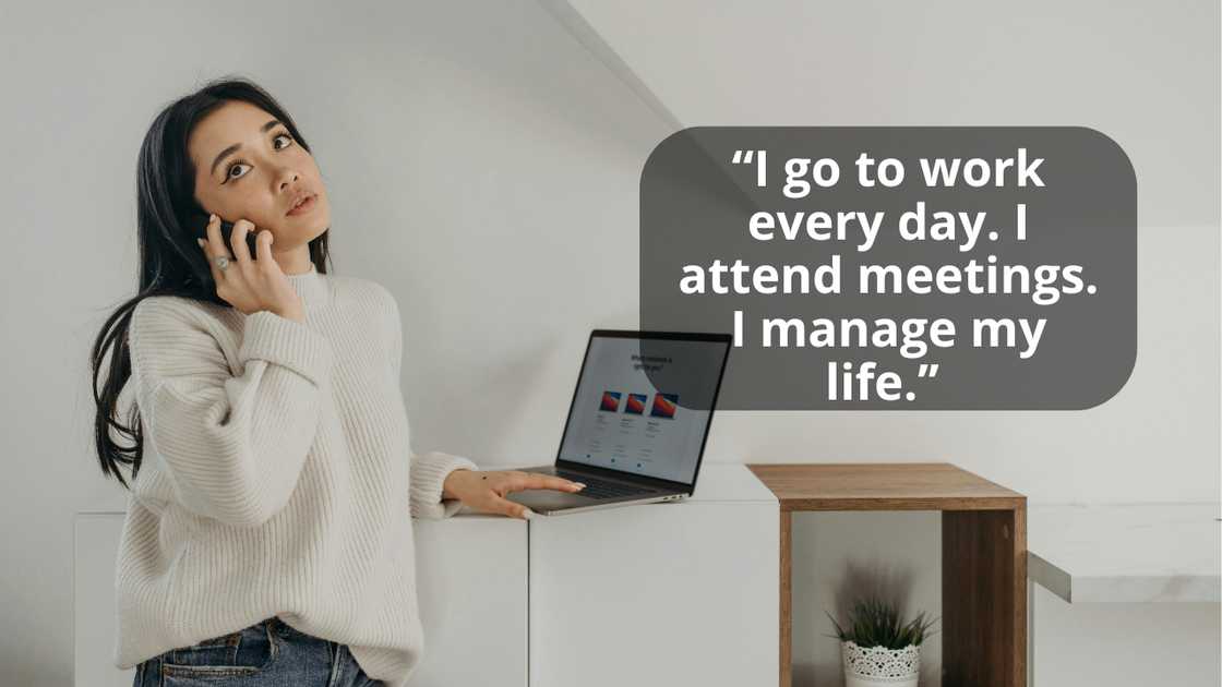 A woman talking on phone while using a laptop