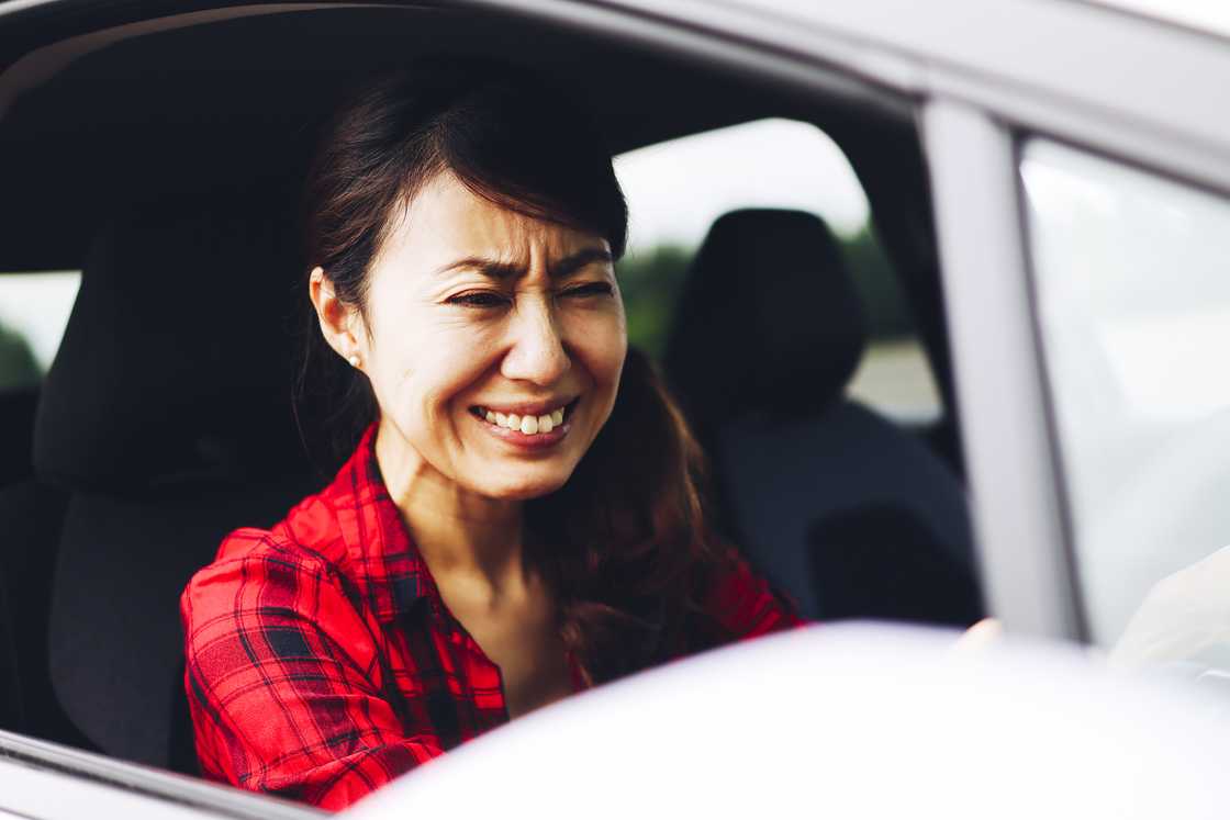 A depressed woman crying in a car A depressed woman crying in a car