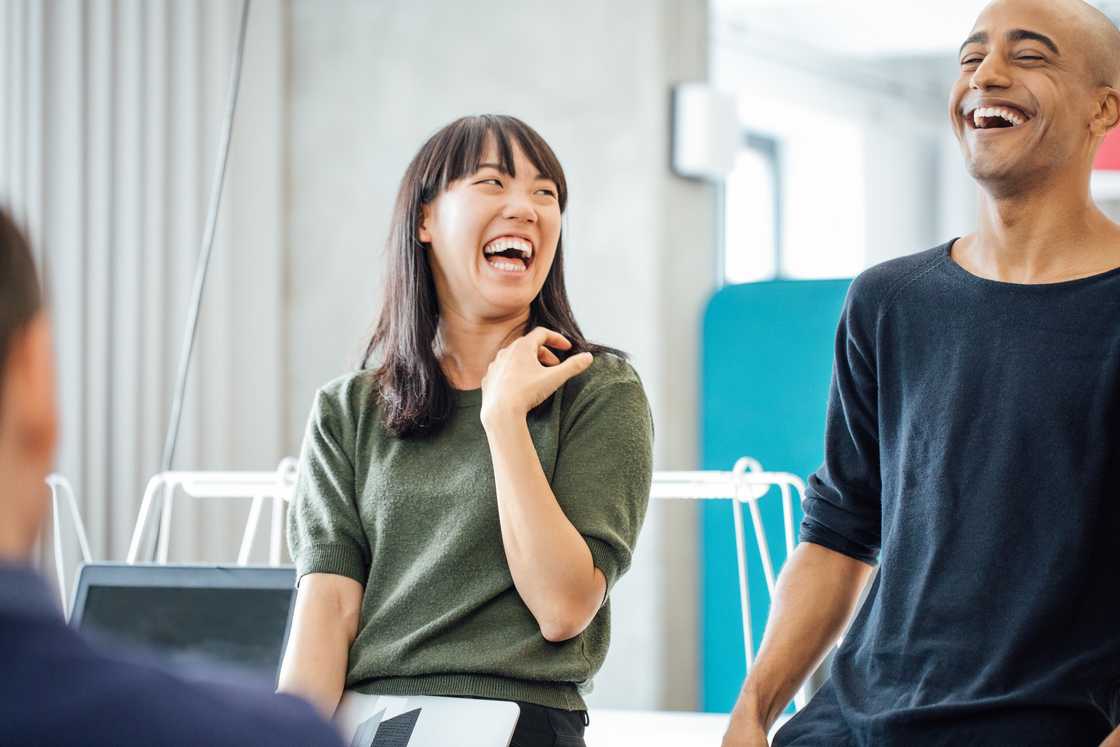 Colleagues laughing in an office