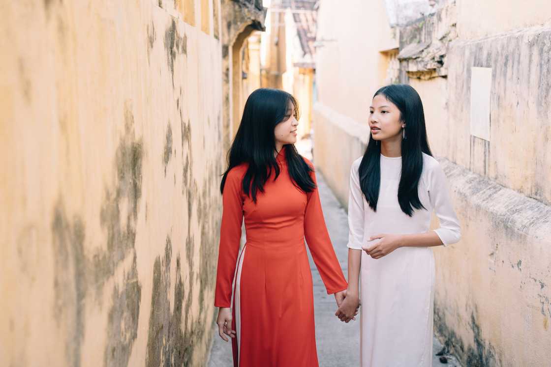 Two siblings talking while holding hands Two siblings talking while holding hands
