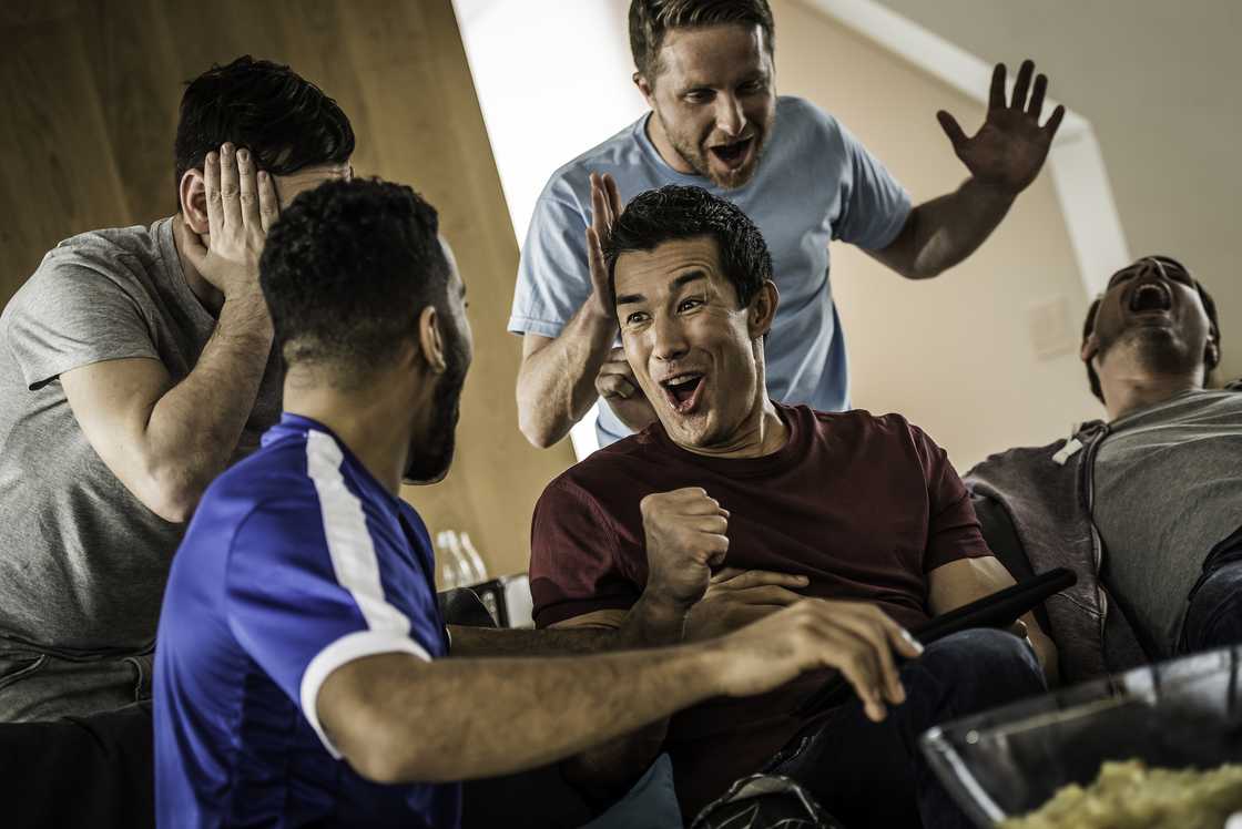 Football fans arguing in a viewing hall