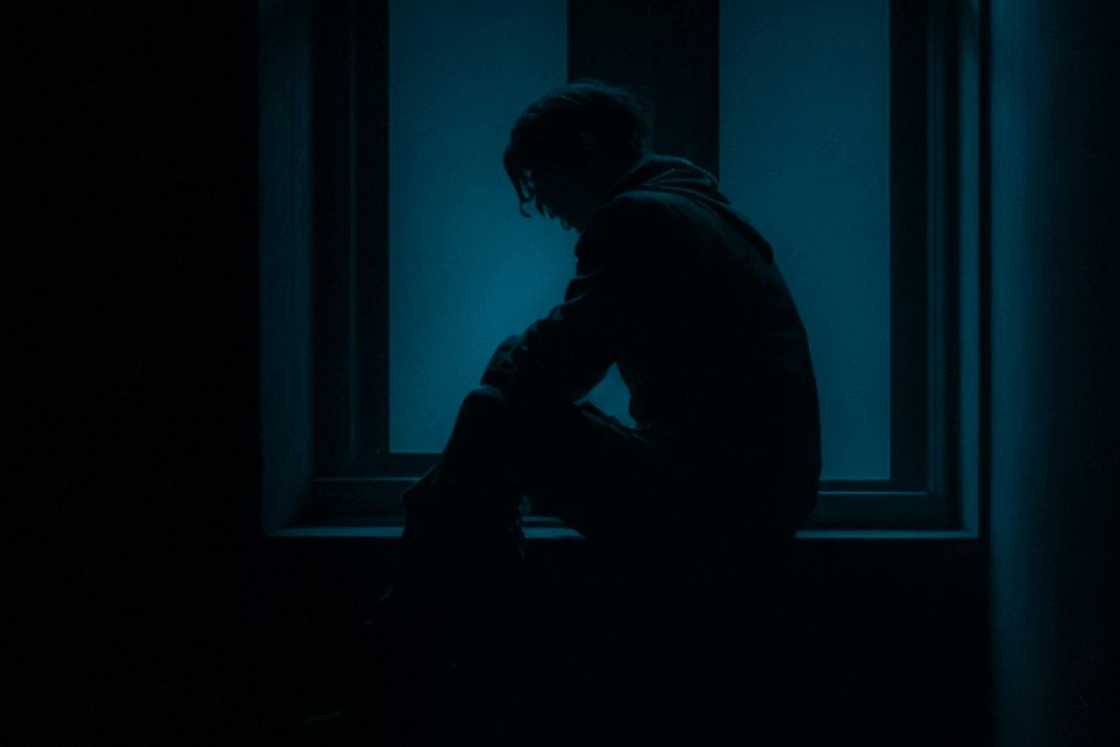 A man sitting in a dark room
