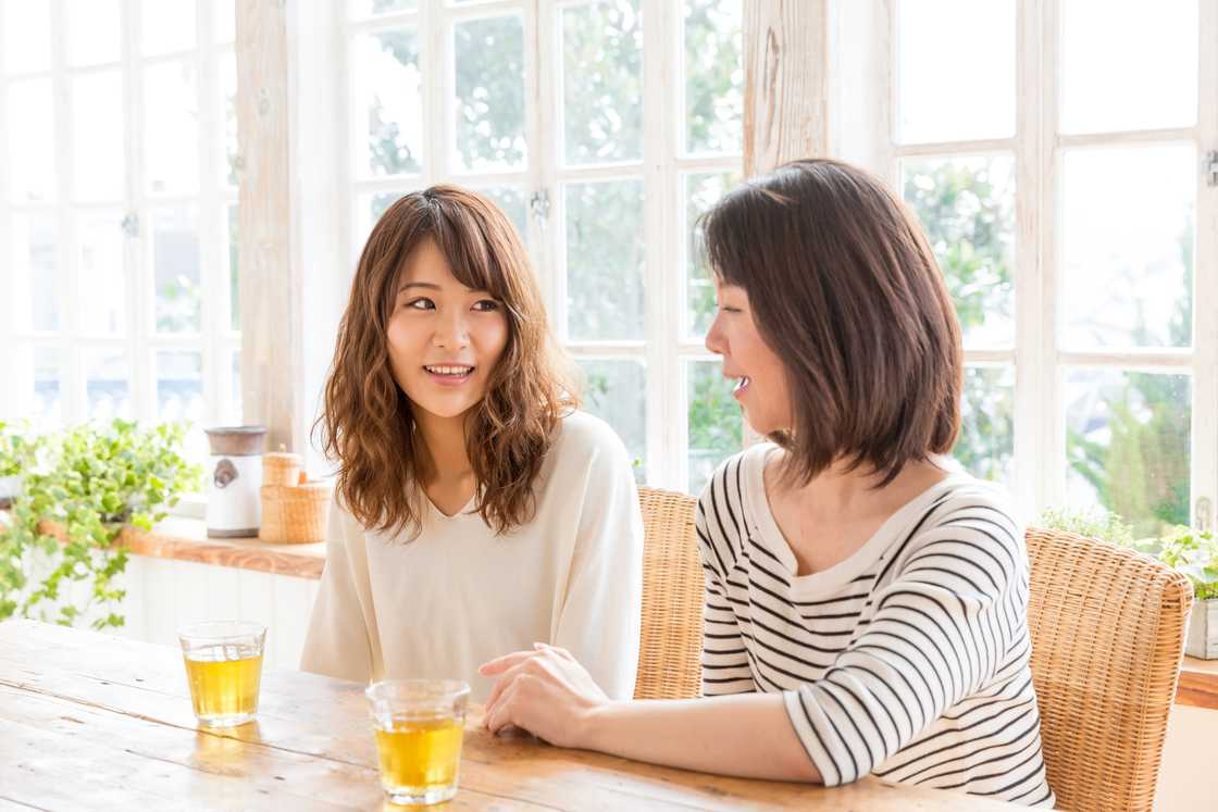 A mother and her adult daughter talking