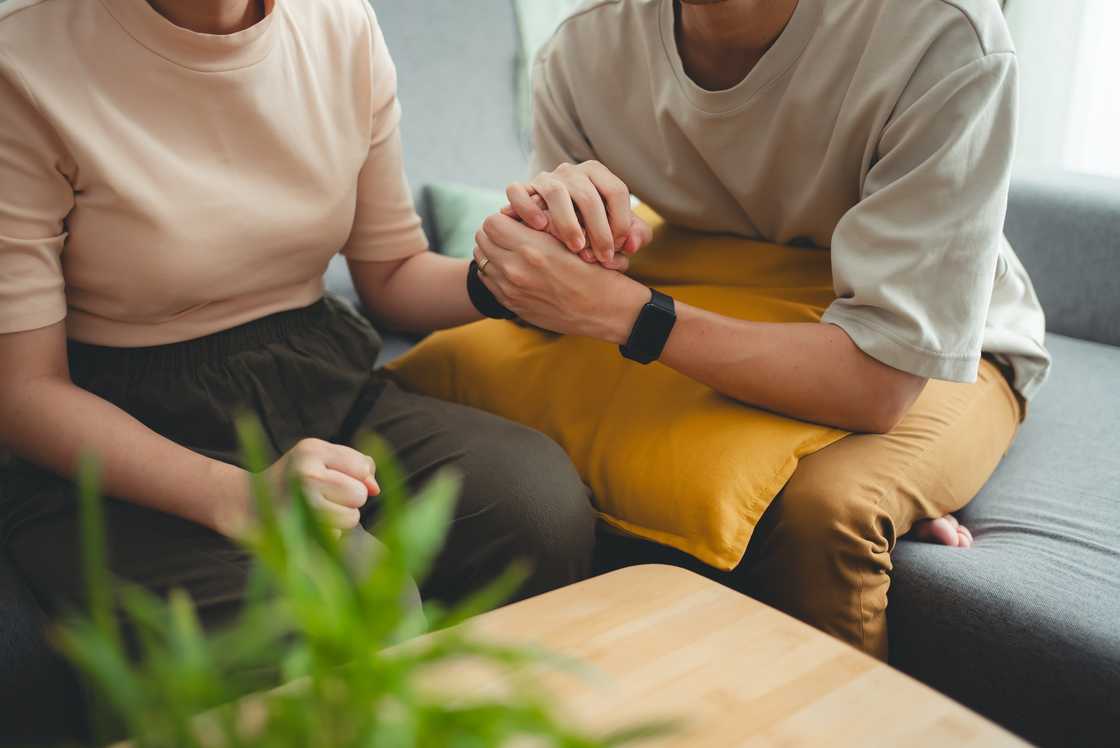 Close up shot of couple holding hands