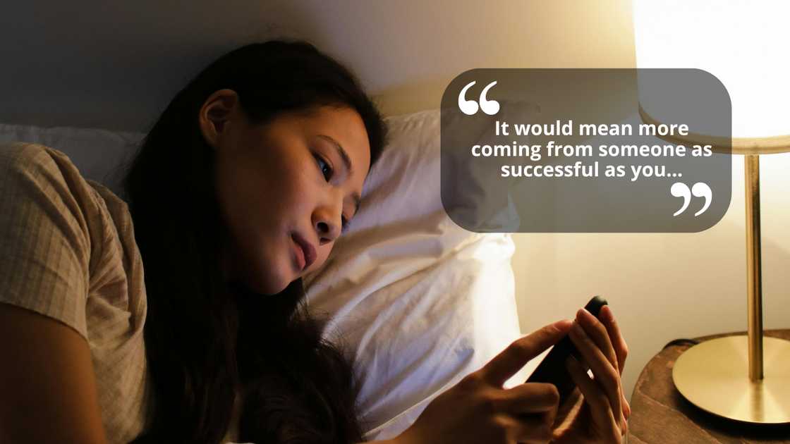 A woman checking her phone at night