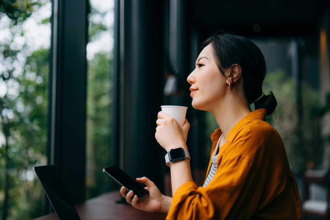 A woman reflecting by the window A woman reflecting by the window