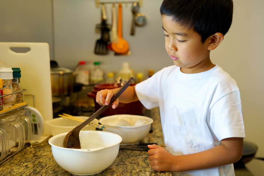A young boy is cooking A young boy is cooking