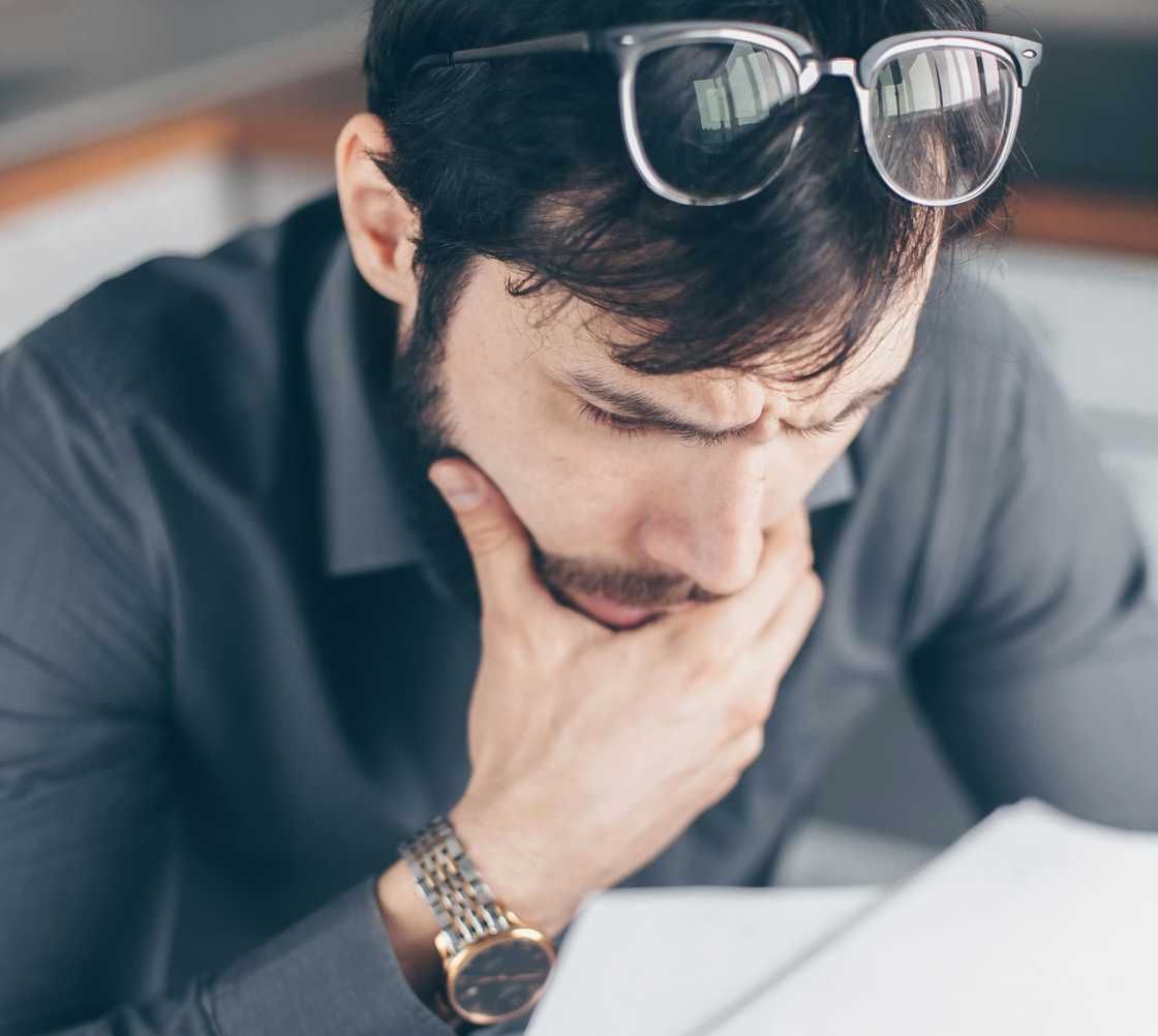 A shocked man reading a document A shocked man reading a document