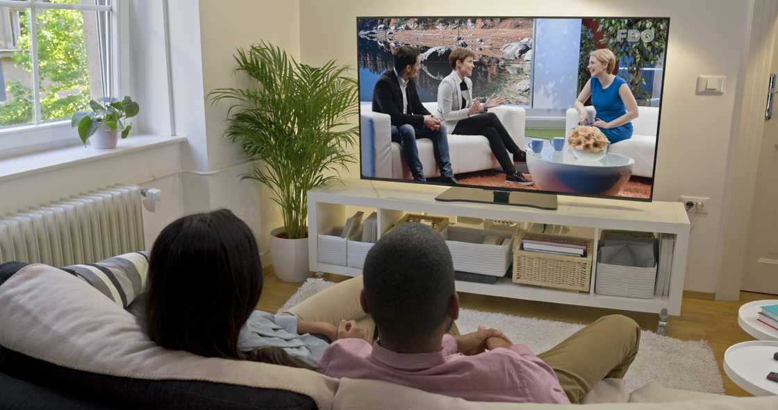 Two people watching news Two people watching news