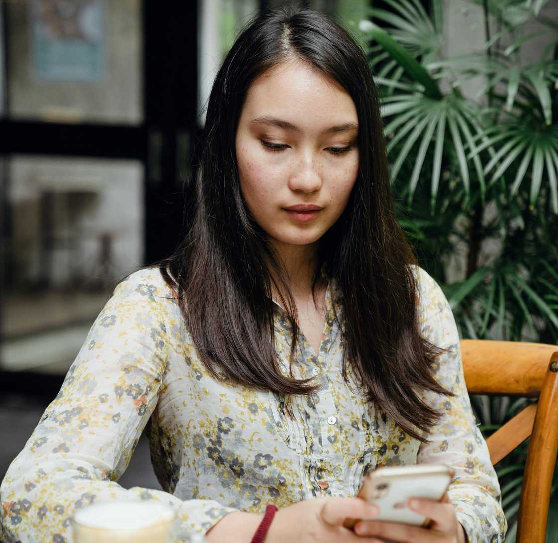 A woman reading something on her phone A woman reading something on her phone