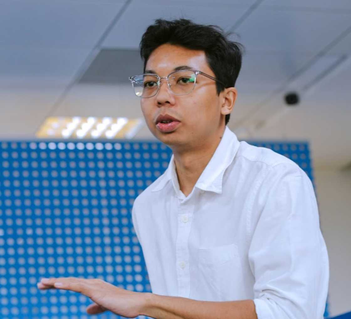 A serious young man in the middle of a conversation in the office