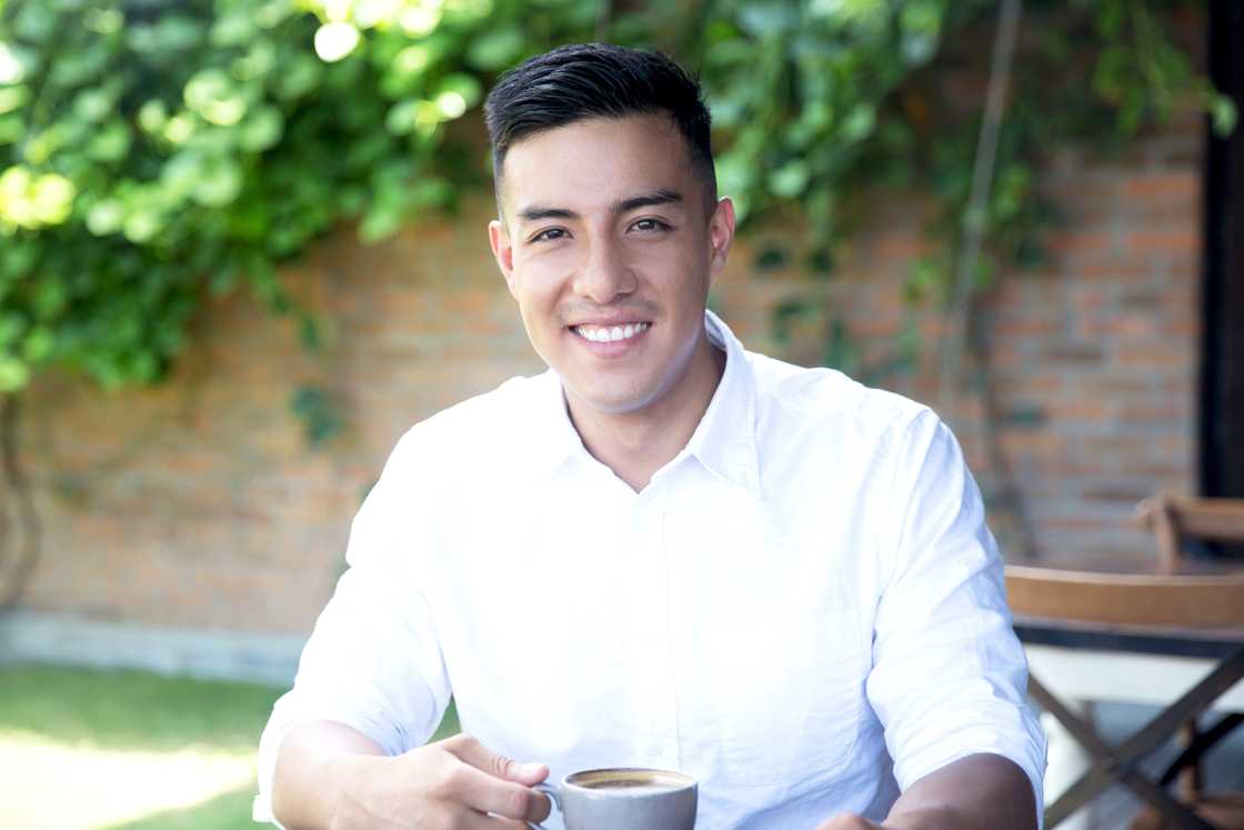 A man taking tea outside A man taking tea outside