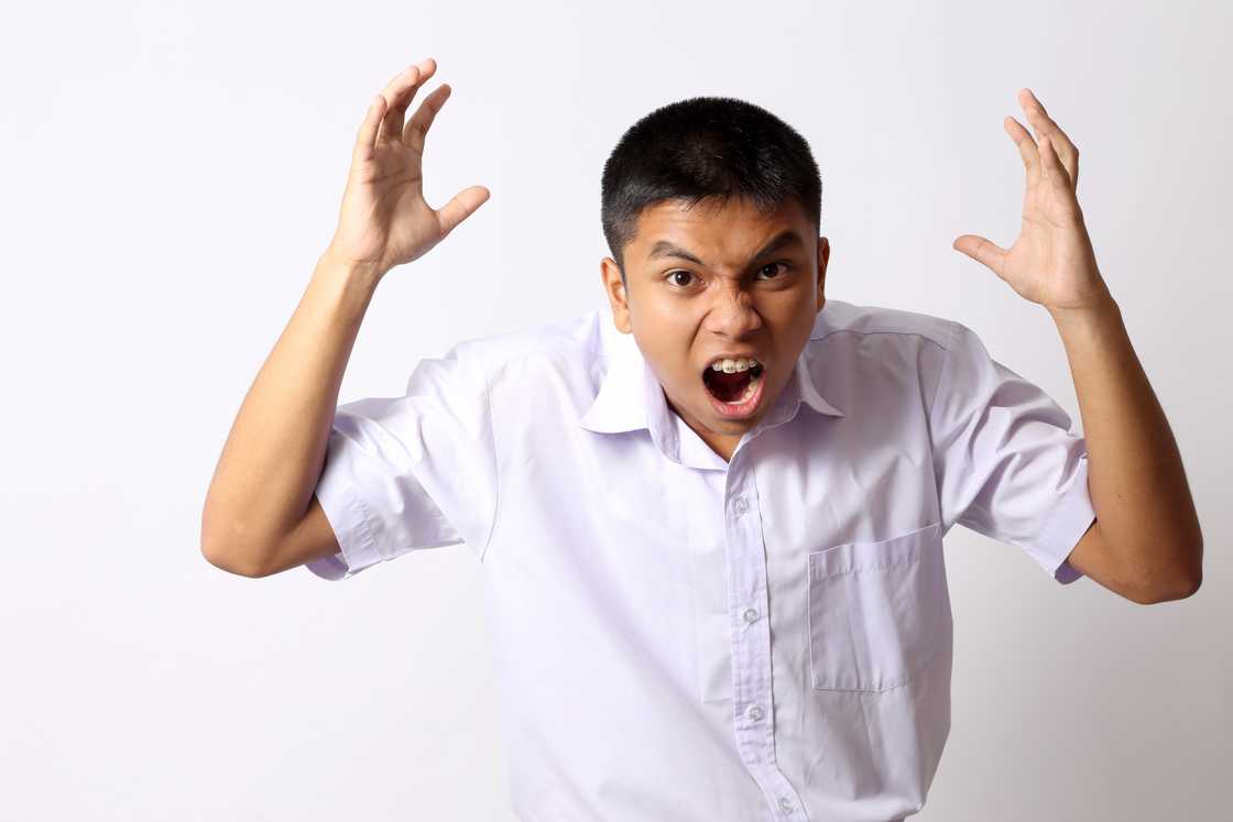A shocked boy in school uniform