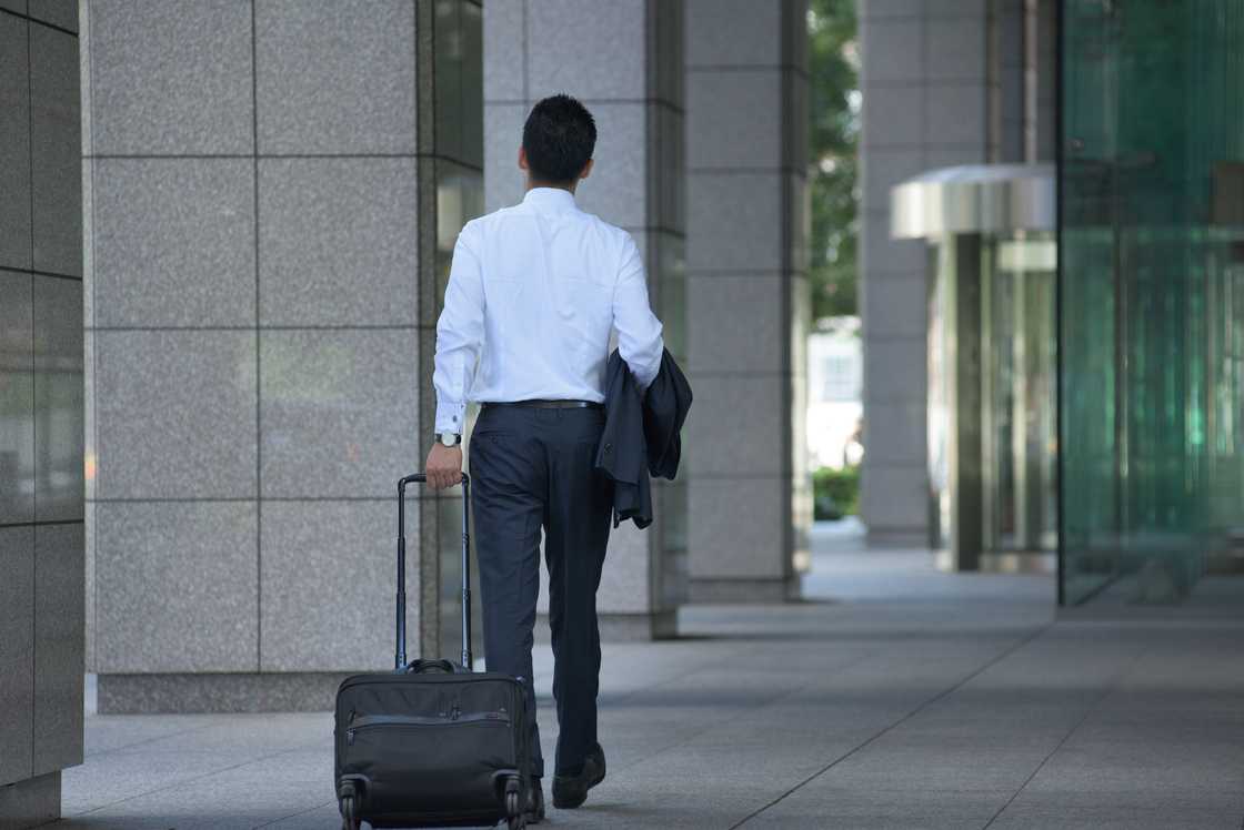 A man with a wheelie bag A man with a wheelie bag