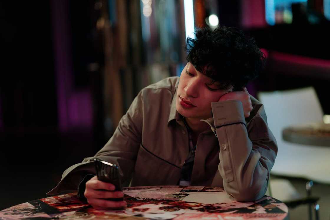 A person scrolls through his smartphone. A person scrolls through his smartphone.