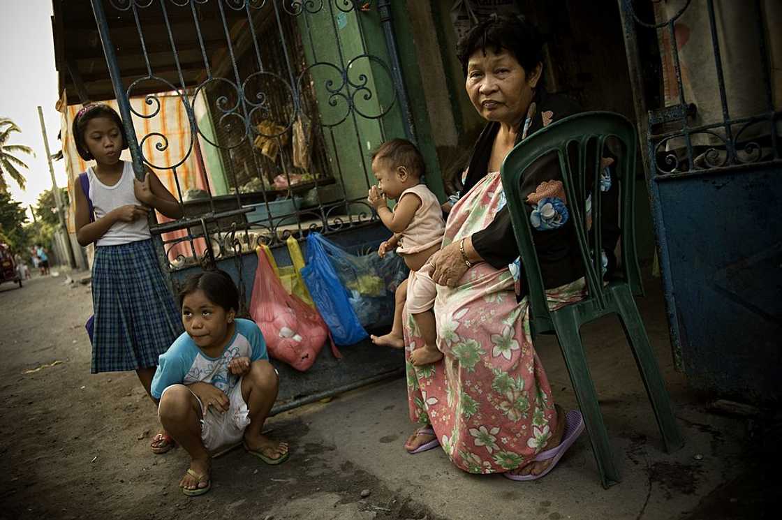 Filipino old woman with her grandchildren Filipino old woman with her grandchildren