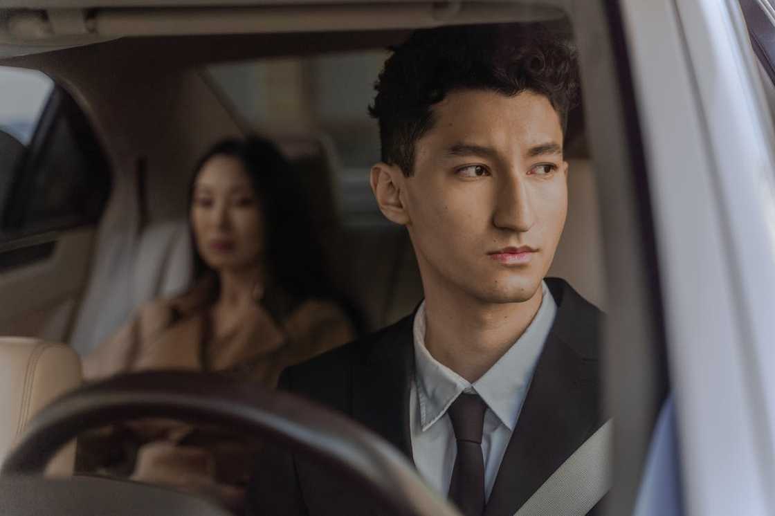 A frustrated passenger stuck in traffic, checking the time.