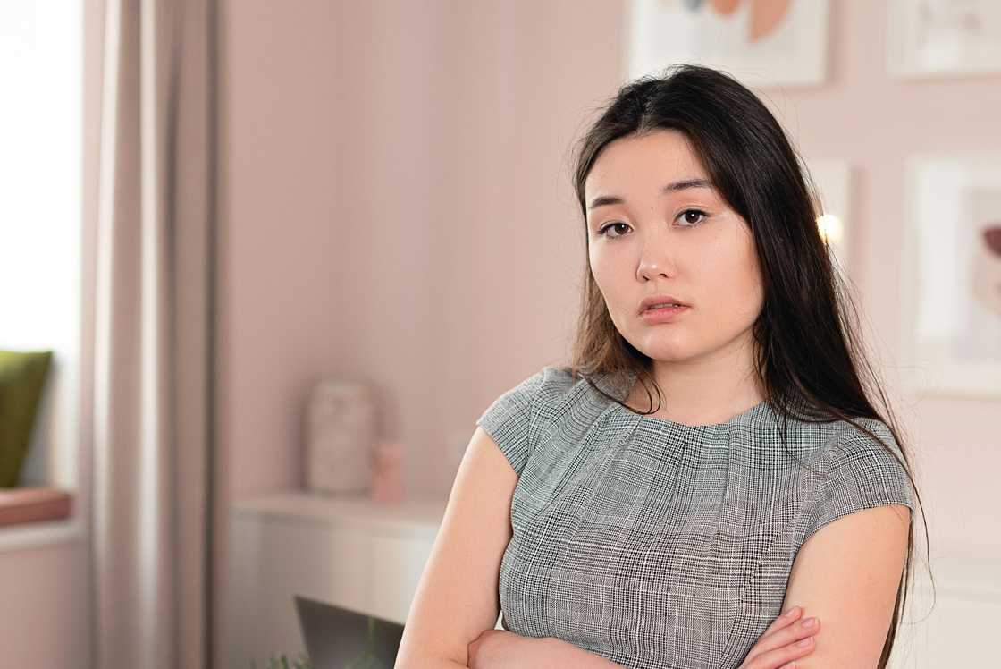 A thoughtful woman with arms crossed