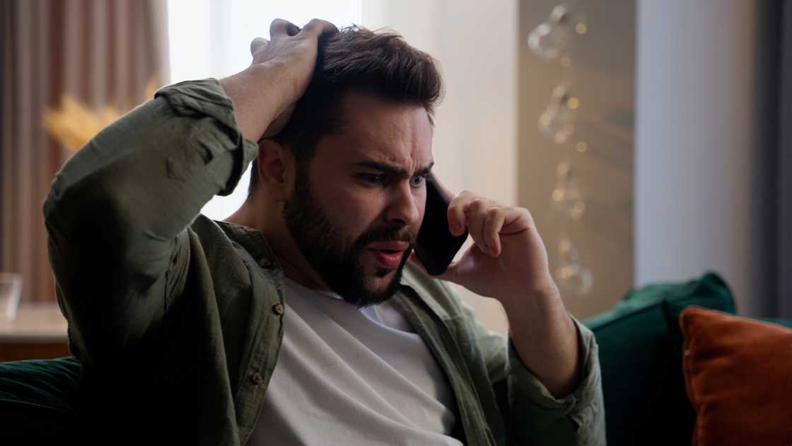 A stressed man on a call