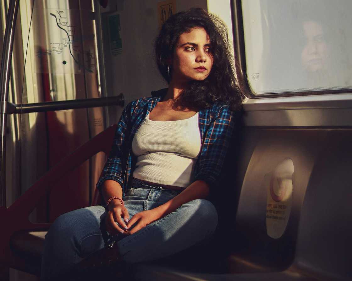 A distressed woman sitting on a train, looking out the window A distressed woman sitting on a train, looking out the window