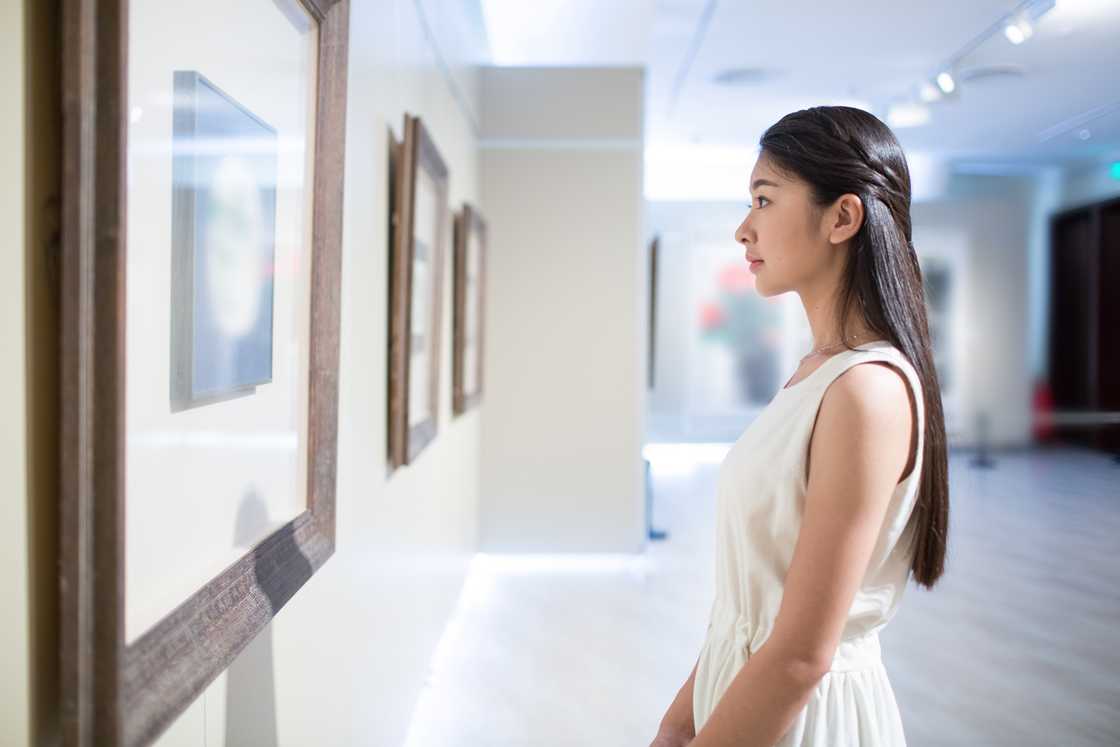 A lady looks at a painting