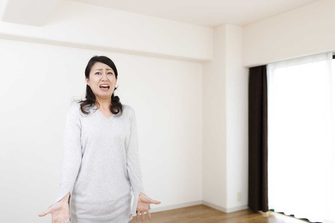 A worried woman yelling at someone in a room A worried woman yelling at someone in a room