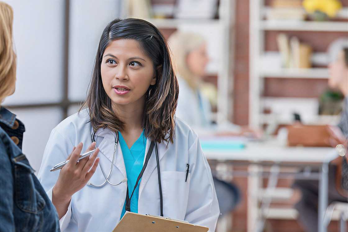 Confident Asian physician talks