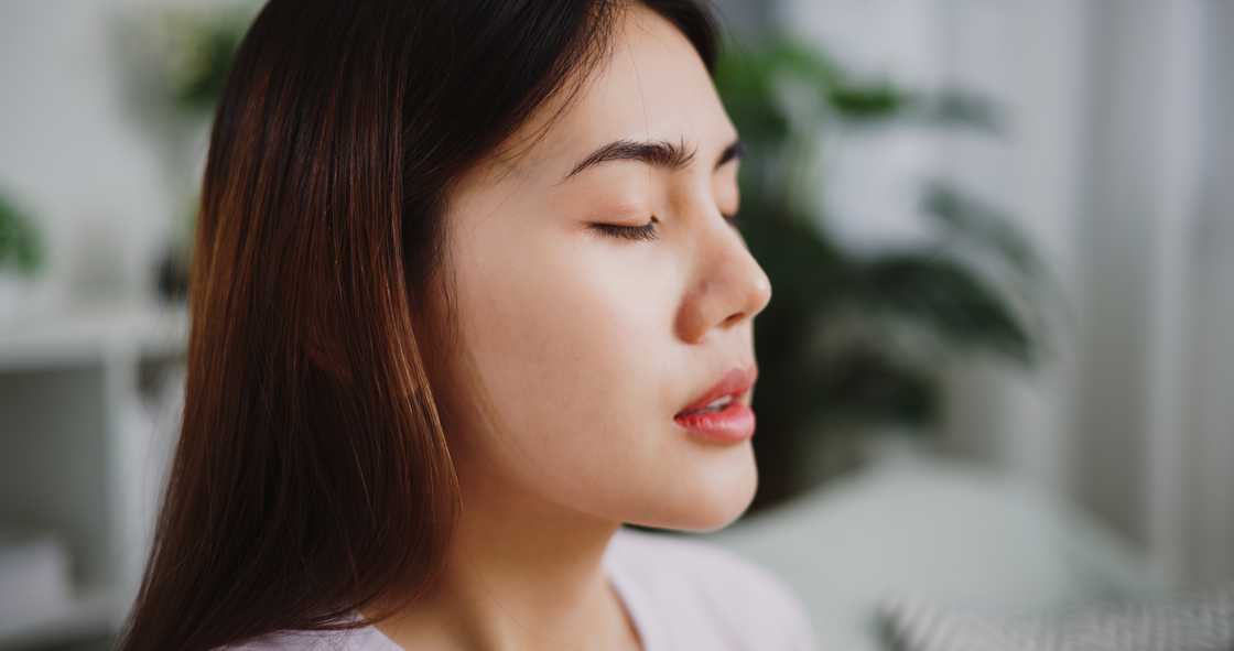 A young woman closing eyes in contemplation