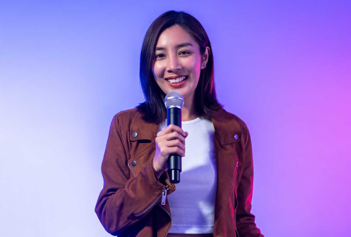 A young woman giving a speech on stage A young woman giving a speech on stage