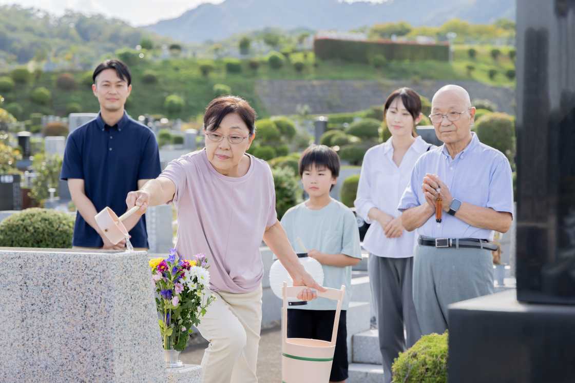 Asian family visiting the grave