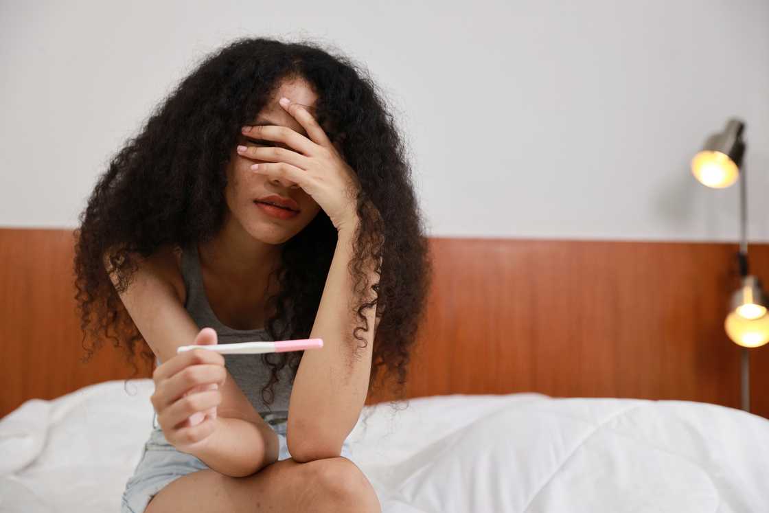 A teenager with a pregnancy test