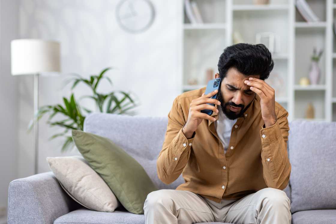 A worried man on a phone call