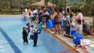 Condominum residents get water from swimming pool due to water crisis