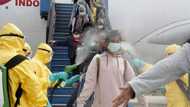 Indonesian officials spray antiseptic to passengers who came from Wuhan, China