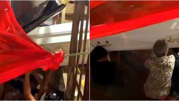 Family joined forces to lift coffin to higher place when floodwater enters home