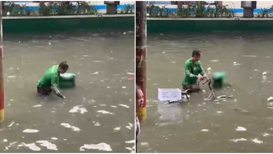 Delivery rider, pilit sinasalba ang lumubog na bisikleta sa abot-baywang na baha sa Maynila