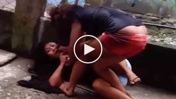 Furious woman is brutally beating her helpless female neighbor
