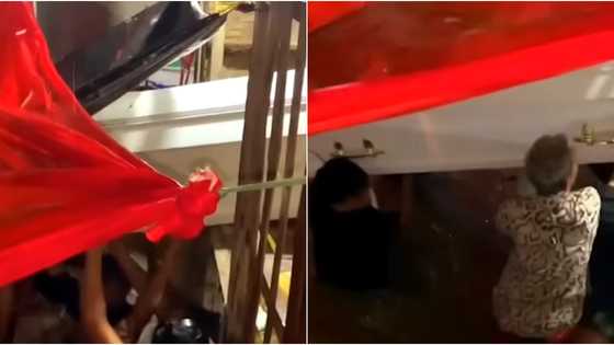 Family joined forces to lift coffin to higher place when floodwater enters home